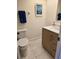 Bathroom featuring tile flooring, a wooden vanity, a mirror, and decorative artwork at 4915 Bay Ne St # 322, St Petersburg, FL 33703