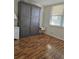 Bedroom with a murphy bed, wood flooring, and a window at 4915 Bay Ne St # 322, St Petersburg, FL 33703