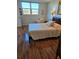 Cozy bedroom with hardwood floors, a comfortable bed, and a sunny window view at 4915 Bay Ne St # 322, St Petersburg, FL 33703