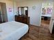 Bedroom with bed, dresser, mirror and view into artist studio space at 4915 Bay Ne St # 322, St Petersburg, FL 33703