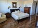 Comfortable bedroom with a queen bed, dresser and lamps in natural lighting at 4915 Bay Ne St # 322, St Petersburg, FL 33703