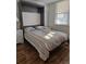 Bedroom with a murphy bed open, wood flooring, and a nightstand at 4915 Bay Ne St # 322, St Petersburg, FL 33703