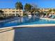 Relaxing community pool area surrounded by lounge chairs and palm trees in front of the building at 4915 Bay Ne St # 322, St Petersburg, FL 33703