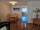 Dining table and chairs near artwork with view into kitchen area at 4915 Bay Ne St # 322, St Petersburg, FL 33703