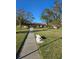 Well manicured front lawn and sidewalk to building with mature trees overhead at 4915 Bay Ne St # 322, St Petersburg, FL 33703