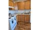 Well-lit kitchen featuring white appliances, wood cabinets and a stainless steel sink at 4915 Bay Ne St # 322, St Petersburg, FL 33703