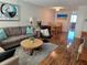 Cozy living room with sofa, chair, wood floors, table and paintings at 4915 Bay Ne St # 322, St Petersburg, FL 33703