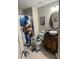 This bathroom has a bowl sink, decorated mirror, and a shower curtain with theme at 4915 Pond Ridge Dr, Riverview, FL 33578