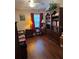 This bedroom features dark wood floors, a daybed, corner shelves, and a bookcase at 4915 Pond Ridge Dr, Riverview, FL 33578