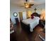 This bedroom features a ceiling fan, dark wood flooring, and a decorative headboard at 4915 Pond Ridge Dr, Riverview, FL 33578