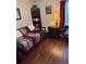 This bedroom has dark wood floors, a trundle daybed, and is decorated with red accents at 4915 Pond Ridge Dr, Riverview, FL 33578