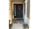 Stylish front door with a decorative wreath and decorative plants for curb appeal at 4915 Pond Ridge Dr, Riverview, FL 33578