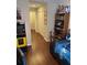 This hallway features dark wood flooring, white doors, and an arcade game at 4915 Pond Ridge Dr, Riverview, FL 33578