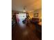 Comfortable living room featuring hardwood floors, a cozy seating area, and bright windows at 4915 Pond Ridge Dr, Riverview, FL 33578