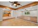 Open-concept living space with wood and tile flooring, seamlessly connecting the living area to the kitchen at 4926 Camellia S Way, St Petersburg, FL 33705