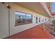 Exterior balcony view of condo with neutral paint, large window and orange flooring on the walkway at 5840 30Th S Ave # 208, Gulfport, FL 33707