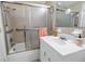 Bathroom with a vanity, mirror, and a shower/tub combination with sliding glass doors at 5840 30Th S Ave # 208, Gulfport, FL 33707