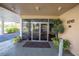 Well-maintained building entrance with glass doors, landscaping, and a welcoming atmosphere at 5840 30Th S Ave # 208, Gulfport, FL 33707