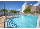 Resort-style pool with pristine blue water, ample seating, and lush landscaping at 5840 30Th S Ave # 208, Gulfport, FL 33707