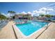 Community pool area showcasing inviting blue water, poolside seating, and tropical landscaping at 5840 30Th S Ave # 208, Gulfport, FL 33707