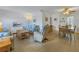 Bright living room with cozy seating, wood floors, and a dining area in an open layout at 5840 30Th S Ave # 208, Gulfport, FL 33707