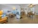 Bright and airy living room offering comfortable seating, wood flooring and views of the dining area at 5840 30Th S Ave # 208, Gulfport, FL 33707