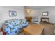 Open-concept living room featuring neutral walls, wood-look flooring, and comfortable seating at 5840 30Th S Ave # 208, Gulfport, FL 33707