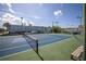 Well maintained tennis court for community use, with a net, lines, and surrounding greenery at 5840 30Th S Ave # 208, Gulfport, FL 33707