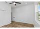 An empty, brightly lit bedroom with hard wood floors and a ceiling fan at 5891 64Th N St, St Petersburg, FL 33713