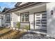 A close-up of the home's front porch highlights the newly paved entryway, modern front door, and manicured greenery at 5891 64Th N St, St Petersburg, FL 33713