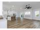 Bright, open-concept living area featuring hardwood floors and modern ceiling fan at 5891 64Th N St, St Petersburg, FL 33713