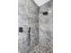 Modern walk-in shower with gray marble style tiles and black shower head at 5891 64Th N St, St Petersburg, FL 33713