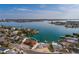 Aerial view of home with water views on the bay, a private dock, and mature tropical landscaping at 7013 Boca Ciega Dr, St Pete Beach, FL 33706