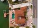 Aerial view of the home showcasing the pool, dock, waterfront location, and brick driveway at 7013 Boca Ciega Dr, St Pete Beach, FL 33706