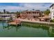 Outdoor living at its finest with this backyard oasis with pool, tiki bar, and dock! at 7013 Boca Ciega Dr, St Pete Beach, FL 33706