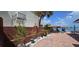 Inviting backyard patio with views of the bay, plants, and dining area for outdoor enjoyment at 7013 Boca Ciega Dr, St Pete Beach, FL 33706