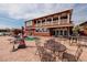 The backyard with a covered eating area, dock, chairs and tables on the patio, and an in-ground pool at 7013 Boca Ciega Dr, St Pete Beach, FL 33706