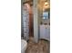 Compact bathroom featuring a shower, vanity, and neutral decor at 7013 Boca Ciega Dr, St Pete Beach, FL 33706