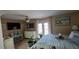 Bright bedroom featuring a ceiling fan, white dresser and furnishings with beachy decor and colors throughout at 7013 Boca Ciega Dr, St Pete Beach, FL 33706