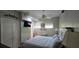Bright bedroom featuring a queen bed, ensuite bathroom, closet, and decor at 7013 Boca Ciega Dr, St Pete Beach, FL 33706