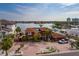 Waterfront home featuring a circular driveway, mature landscaping, and beautiful water views at 7013 Boca Ciega Dr, St Pete Beach, FL 33706