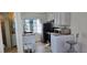 The kitchen features white cabinets and stainless steel appliances at 7013 Boca Ciega Dr, St Pete Beach, FL 33706