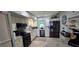 Galley kitchen with white cabinets, stainless appliances, and granite countertops provides a stylish and functional space at 7013 Boca Ciega Dr, St Pete Beach, FL 33706