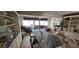 Open living area with waterfront view, featuring a blend of textures and an inviting decor and bar top at 7013 Boca Ciega Dr, St Pete Beach, FL 33706