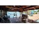 Relaxing covered patio with stunning waterfront views and comfortable seating, creating a perfect outdoor retreat at 7013 Boca Ciega Dr, St Pete Beach, FL 33706