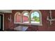 View of outdoor patio featuring table with chairs and arched windows at 7013 Boca Ciega Dr, St Pete Beach, FL 33706