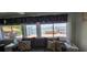 Living room showcasing serene water views through large windows, with comfortable seating and stylish decor at 7013 Boca Ciega Dr, St Pete Beach, FL 33706