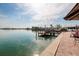 Peaceful waterfront view from a patio with a private dock, perfect for relaxing and enjoying the scenery at 7013 Boca Ciega Dr, St Pete Beach, FL 33706