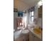 Well-lit bathroom with a yellow sink and coastal decor providing a relaxing atmosphere at 7129 El Rancho Way, Zephyrhills, FL 33541