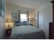Comfortable bedroom with a cozy bed and coastal themed decor throughout at 7129 El Rancho Way, Zephyrhills, FL 33541